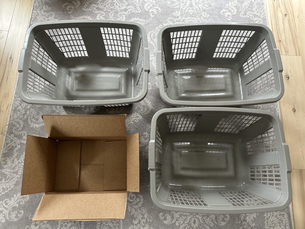 three laundry baskets and a cardboard box