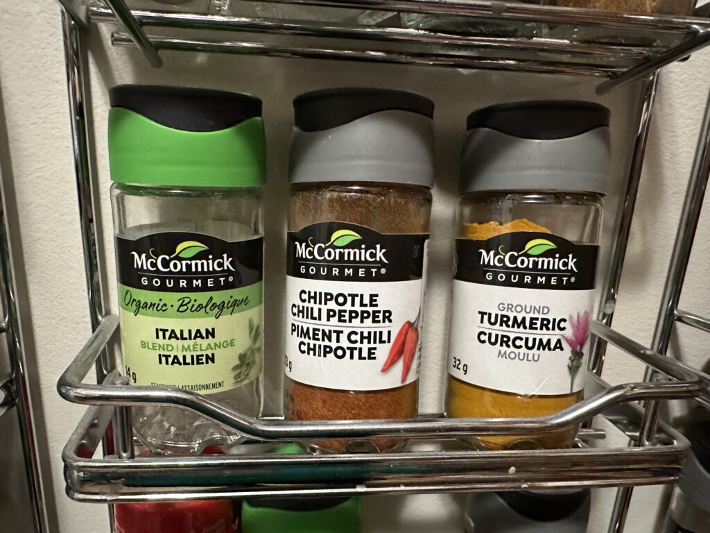 three spices sitting on wall rack should be decluttered when expired