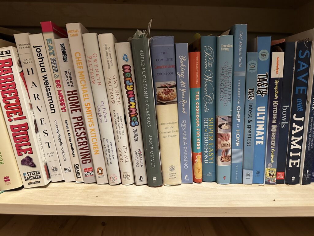 over twenty cookbooks on their sides. tip is to organize cookbooks by colour size or cuisine after you declutter. 