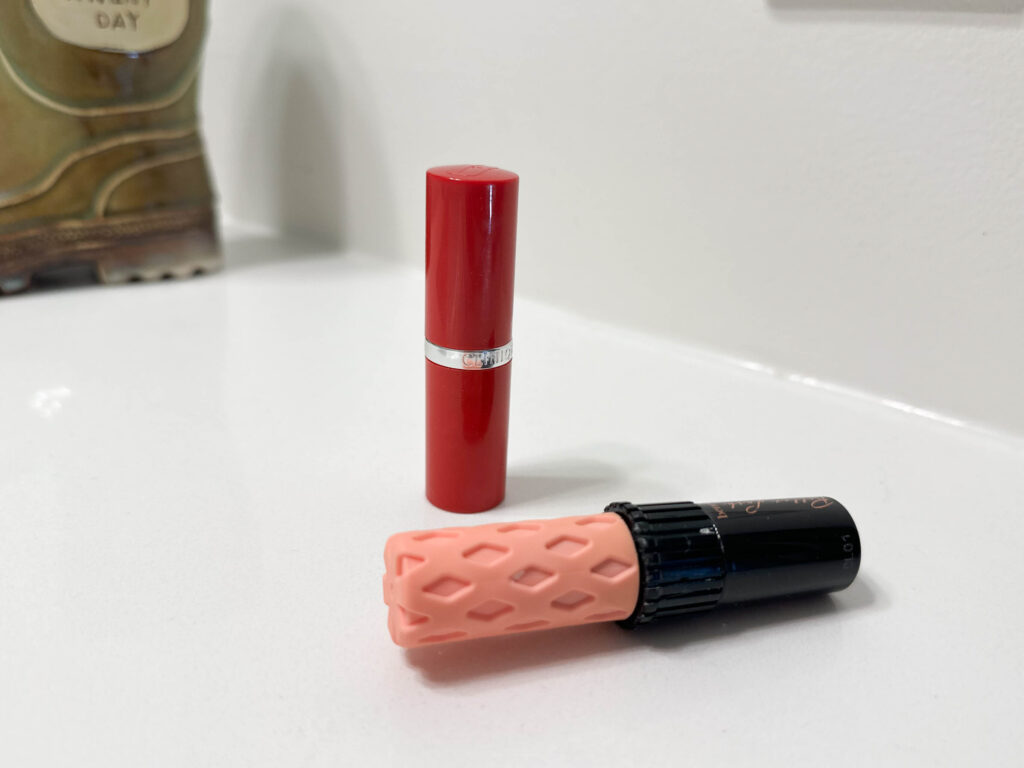 old lipstick and mascara on a counter. going through makeup is a tip to declutter and organize