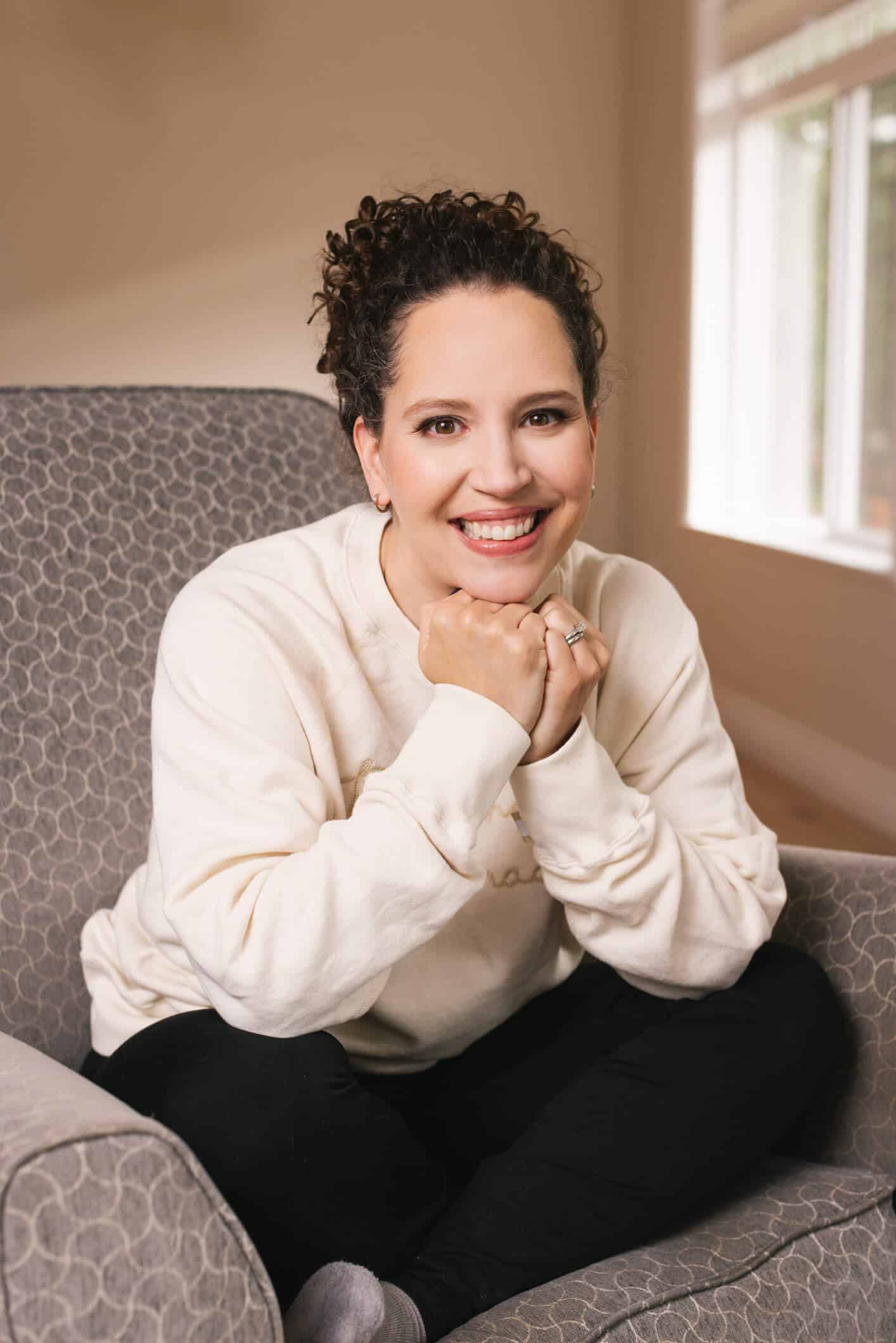 Robyn Buchanan sitting on a chair in a minimal room