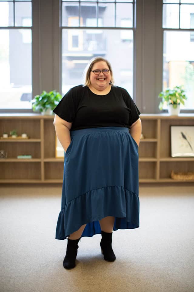 beautiful lady wearing plus-sized capsule wardrobe with black top and blue long skirt