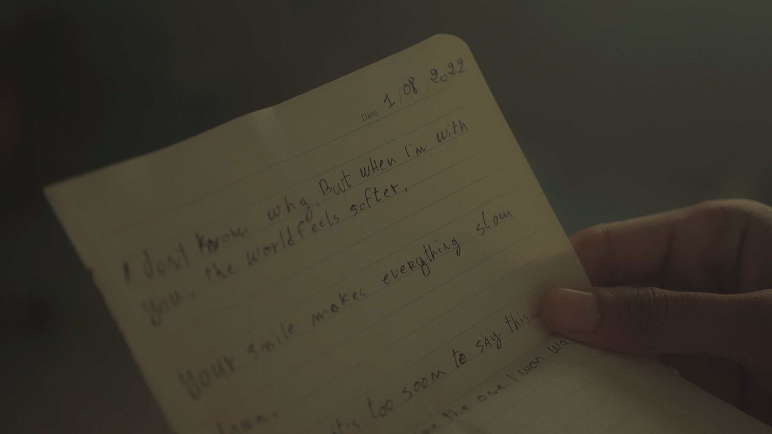A heartfelt handwritten note expressing love and emotions in soft lighting.