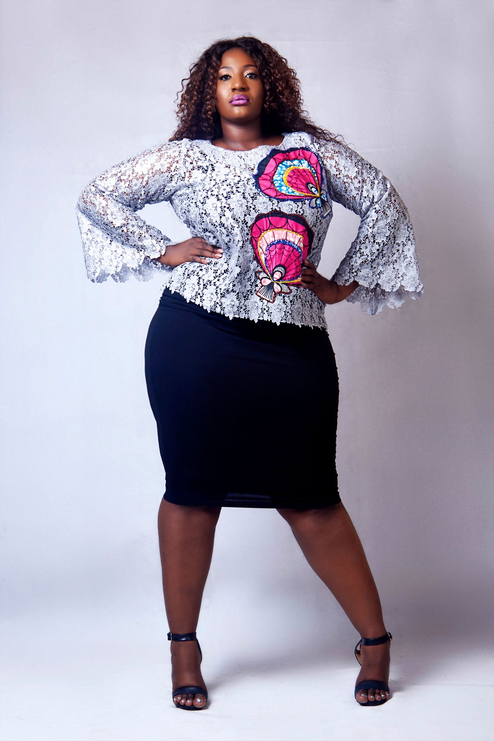 Confident woman posing in stylish plus size fashion wear.